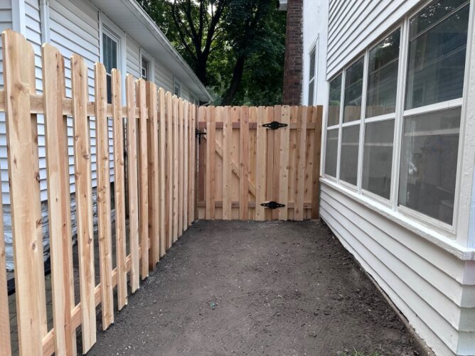 Newly installed wooden privacy fence along a residential property