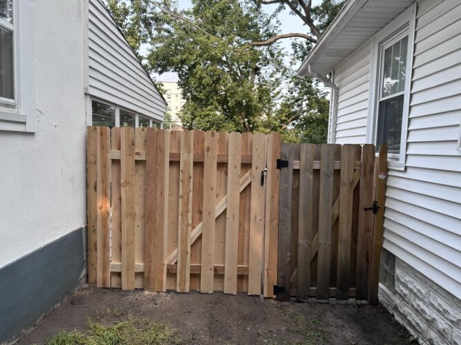 Newly installed wooden privacy fence along a residential property
